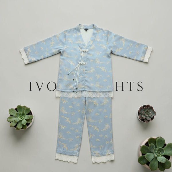 Blue crane print lace trim pyjama set by Ivory Nights - flat lay