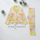Houndstooth printed satin pyjama set by Ivory Nights - styled flat lay