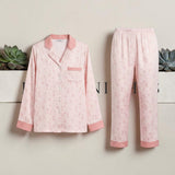 Pink floral print satin pyjama set by Ivory Nights - flat lay front