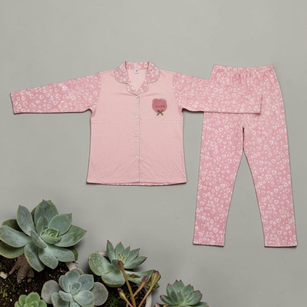 Pink Heart Print PJ Set - flat lay showing pink top with heart print sleeves and matching trousers